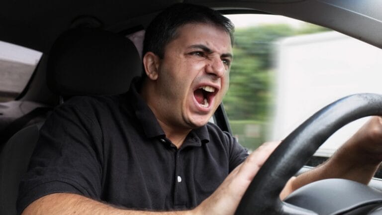 angry man driving a vehicle without seat belt