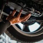 Car mechanic drain the old automatic transmission fluid