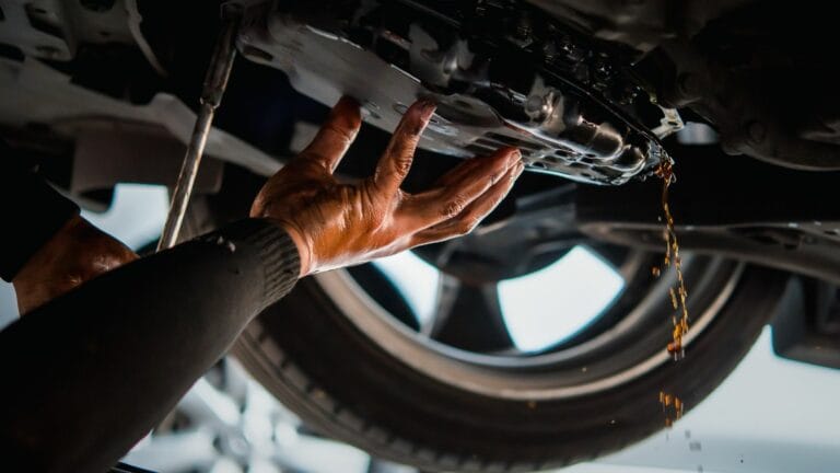 Car mechanic drain the old automatic transmission fluid