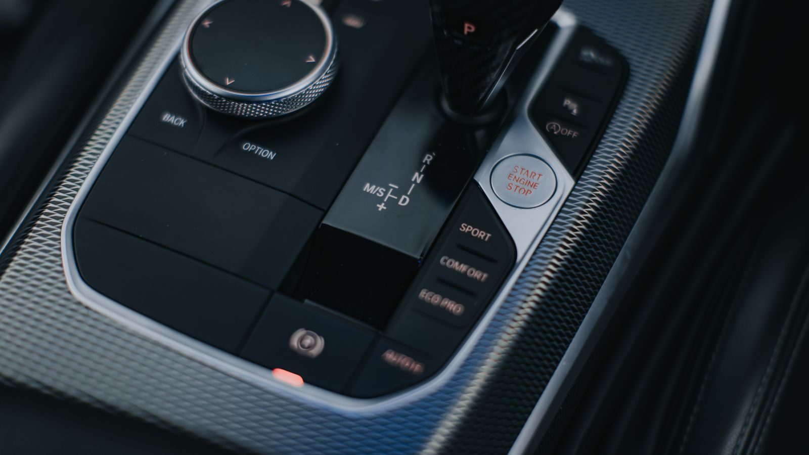 Kuala Ketil, Kedah, Malaysia – 7 December 2023: A close-up of the gear selector, iDrive controller, and driving mode buttons in the interior of a modern BMW vehicle.