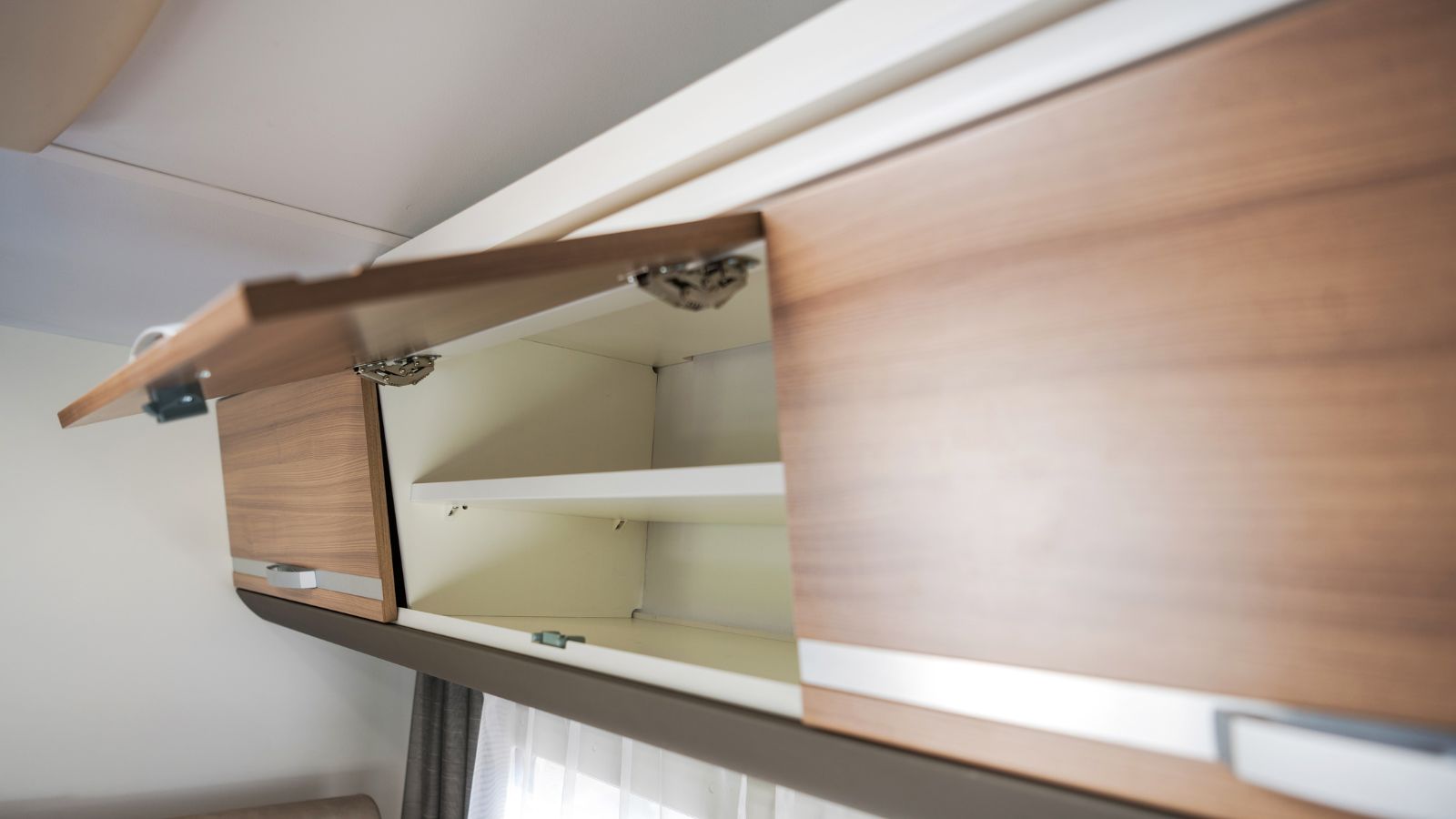 Elegant Camper Van Overhead Cabinet Storage Area. Modern Motorhome RV Recreational Vehicle Features.