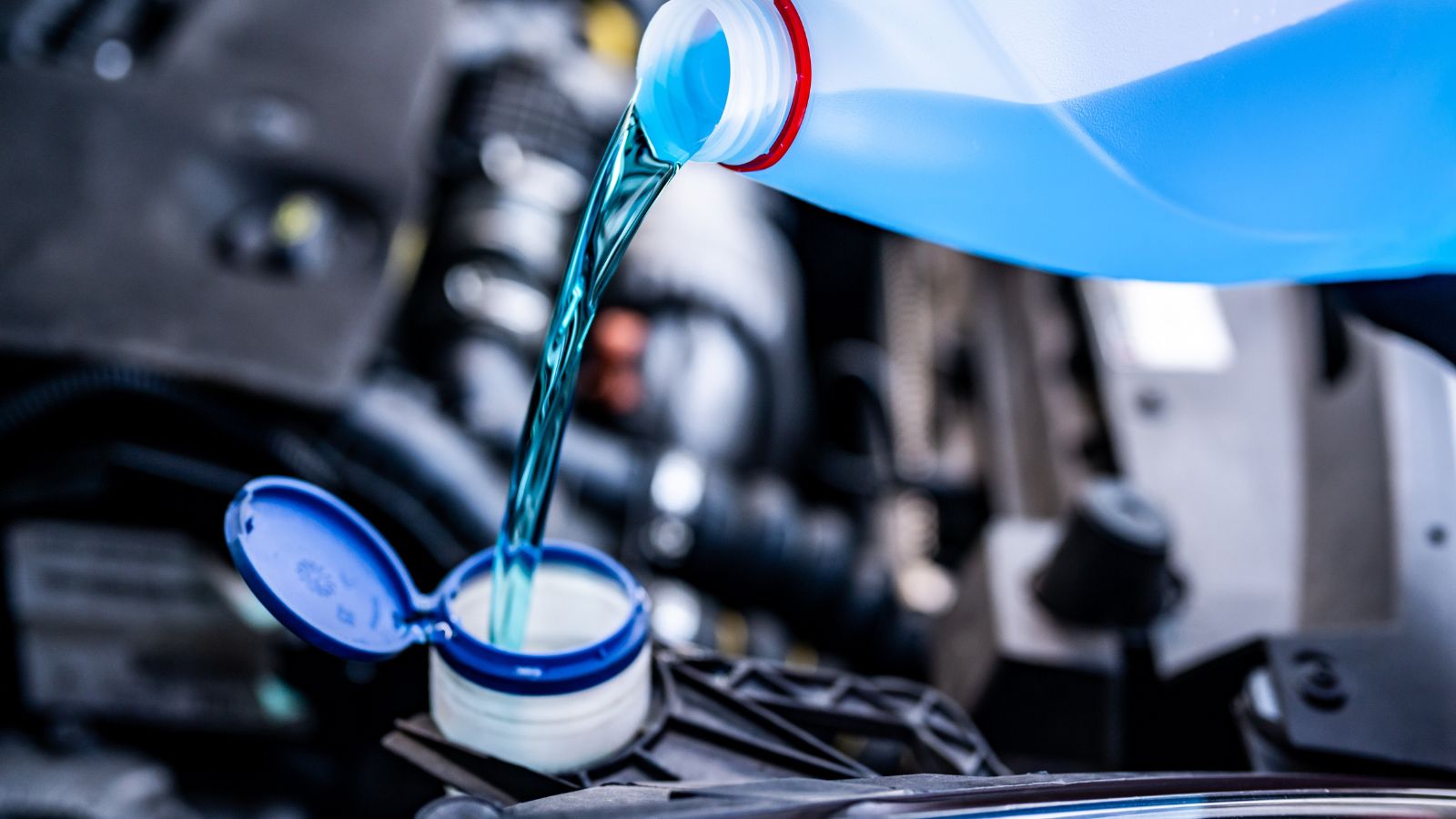 Filling a windshield washer tank with an antifreeze in winter cold weather