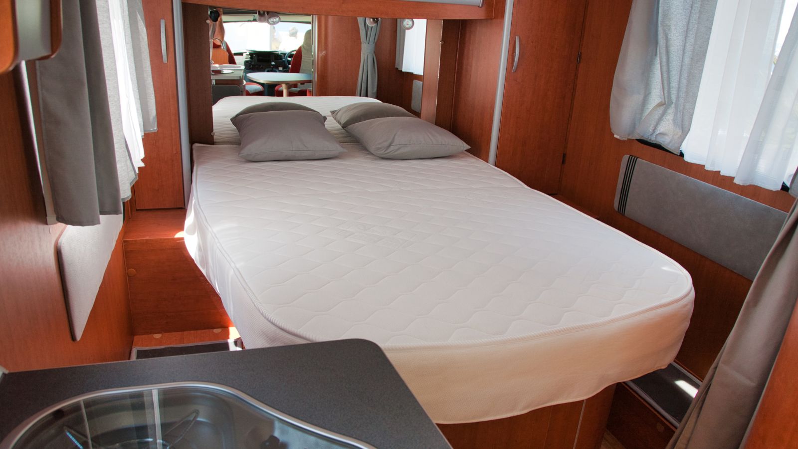 Devon England. Interior of a coach built motor home showing a luxury fixed double bed with rear mirror