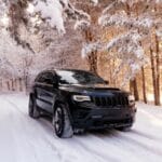 Jeep grand cherokee wk2 Trackhawk. The car is in the forest in winter. snowy forest