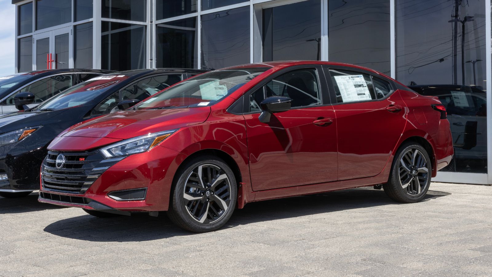 Nissan Versa SR sedan display at a dealership. Nissan offers the Versa with a 1.6L DOHC 4-Cylinder engine. MY2025