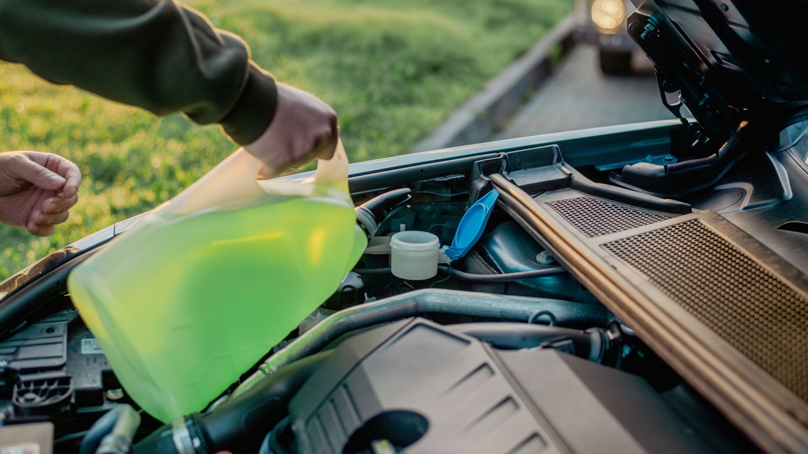 Pouring windshield washer fluid