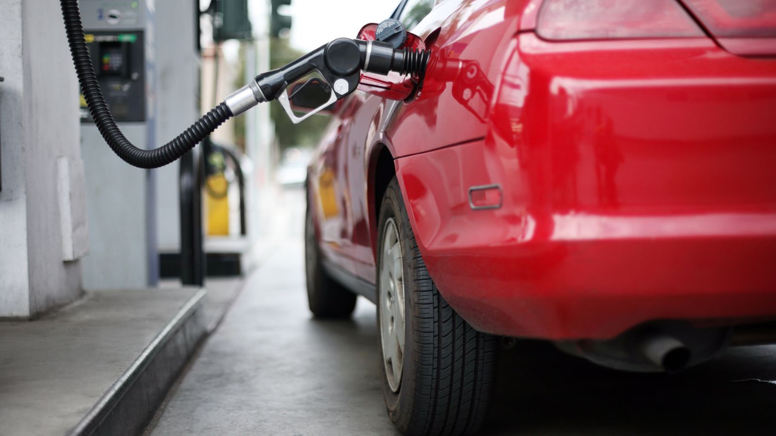 Red car at gas station