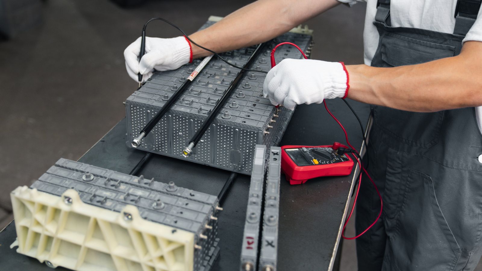 Serviceman repairs electric battery pack of hybrid car