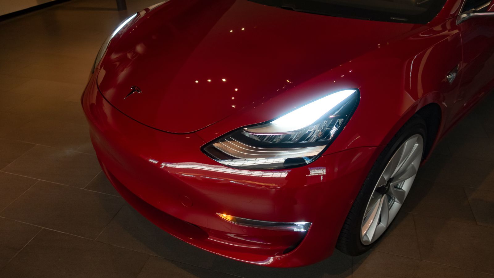 Tesla Model 3 in darkness with turning on headlights