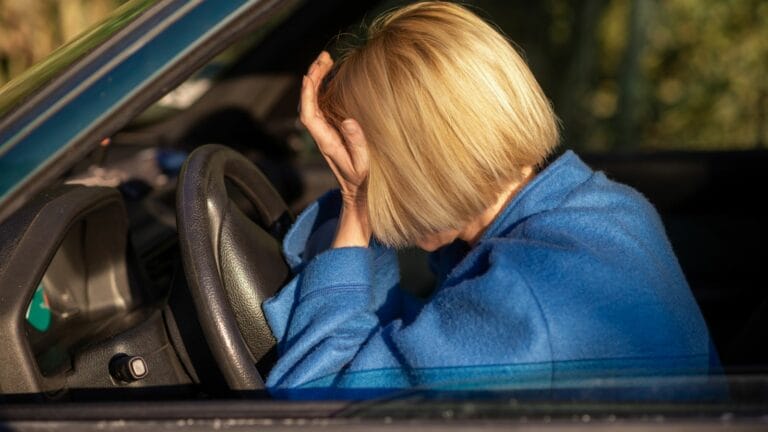 Tired woman driving a car