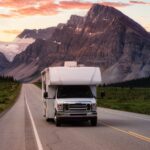 White RV Driving on route. Taken in Icefields Parkway, Banff National Park, Alberta, Canada.