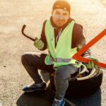 Worker or driver repairing a car