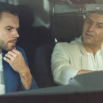 client in car at showroom