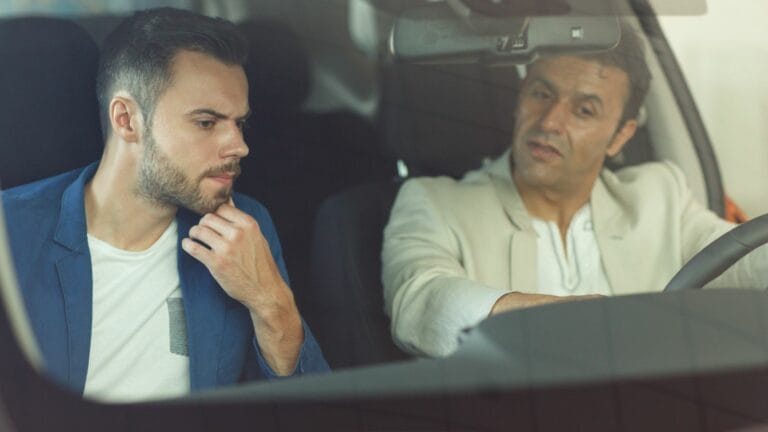 client in car at showroom