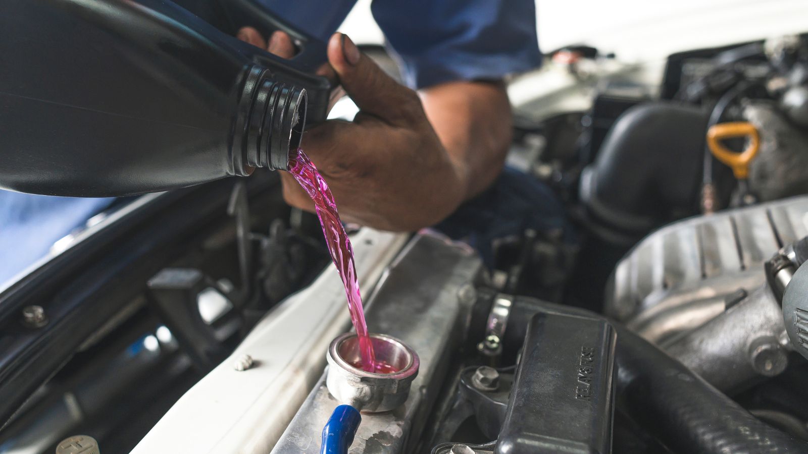 filling Pre-mixed Super Long Life Coolant fluid in Aluminum car radiator fill hole