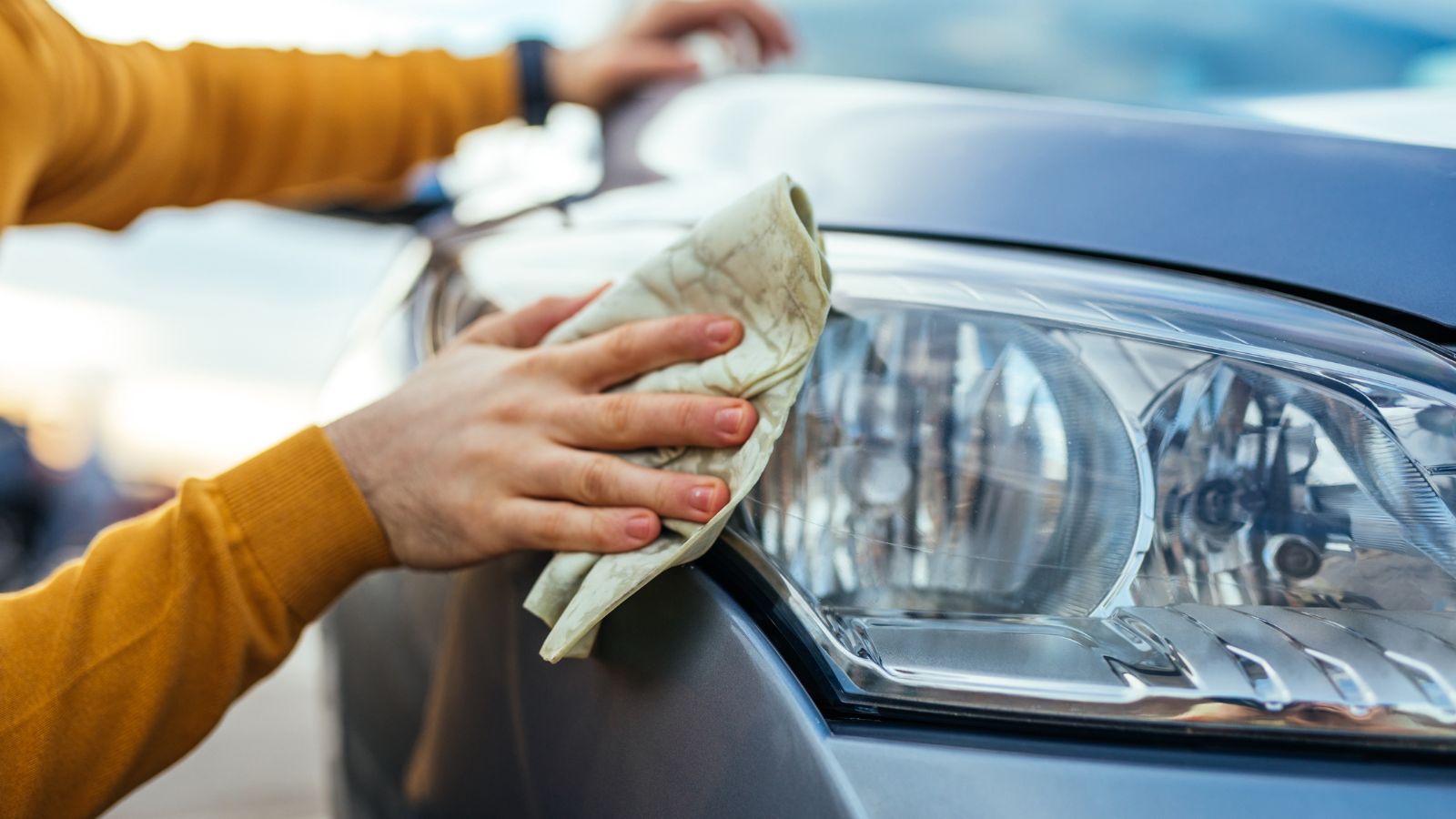 man polishing his car with a cloth, Headlight