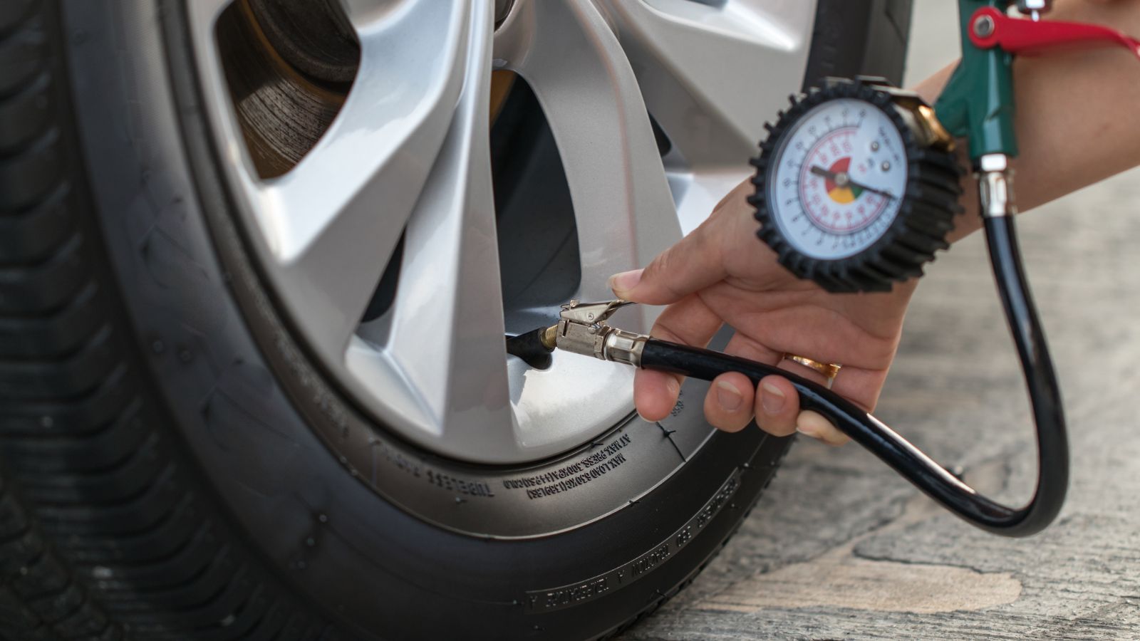 Inflating the tires car and checking air pressure.