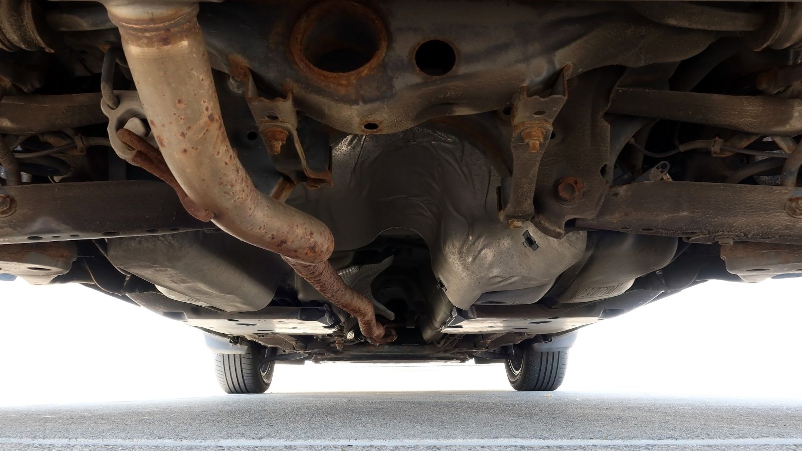 Car with Visible Exhaust System and Rust