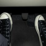 Foot stepping on the accelerator and clutch pedal in manual car