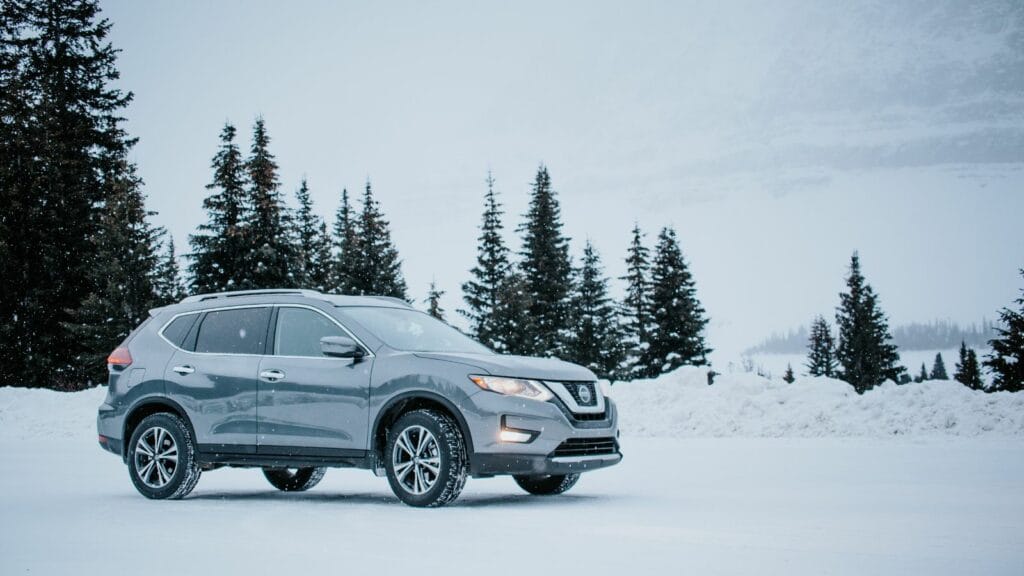 Grey Nissan Rogue parked amidst snowy winter