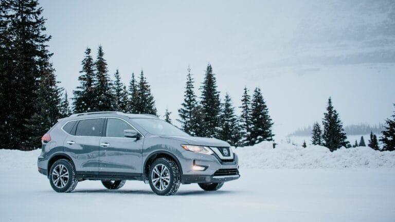Grey Nissan Rogue parked amidst snowy winter