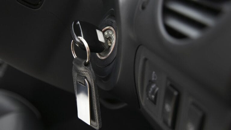Key inserted into the lock of ignition of the car