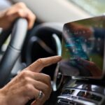 Older man sitting in camper van using gps navigation map