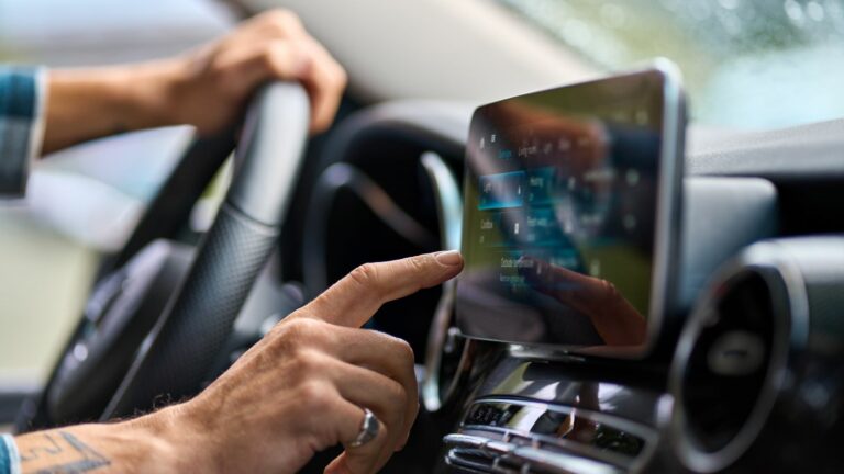 Older man sitting in camper van using gps navigation map