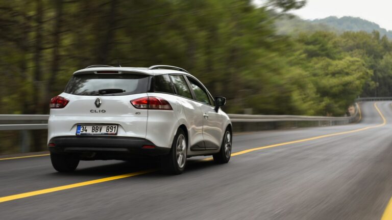 Renault Clio dci drive by forest road in mountains