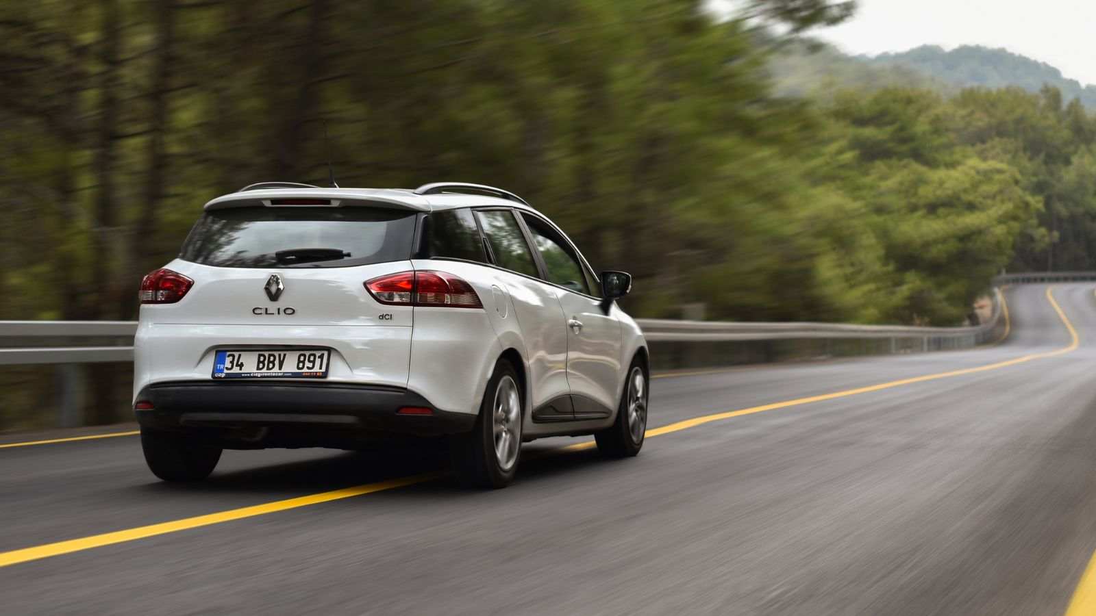 Renault Clio dci drive by forest road in mountains