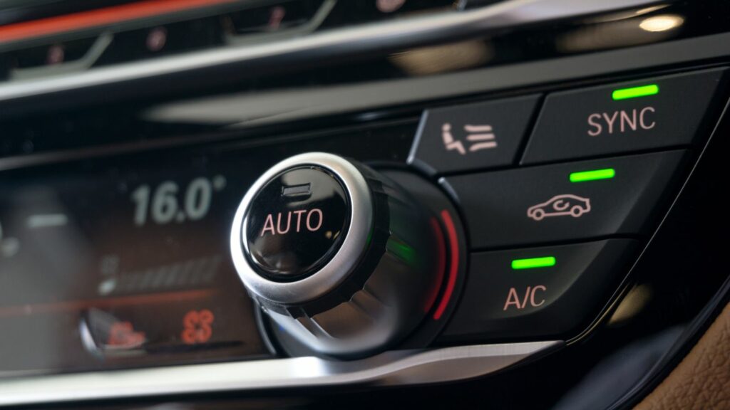 Selective focus of Vehicle Air Conditioning Control System. AC Recirculation Button on dashboard in luxury car