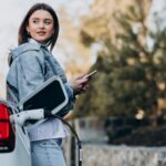 Woman charging her electric car