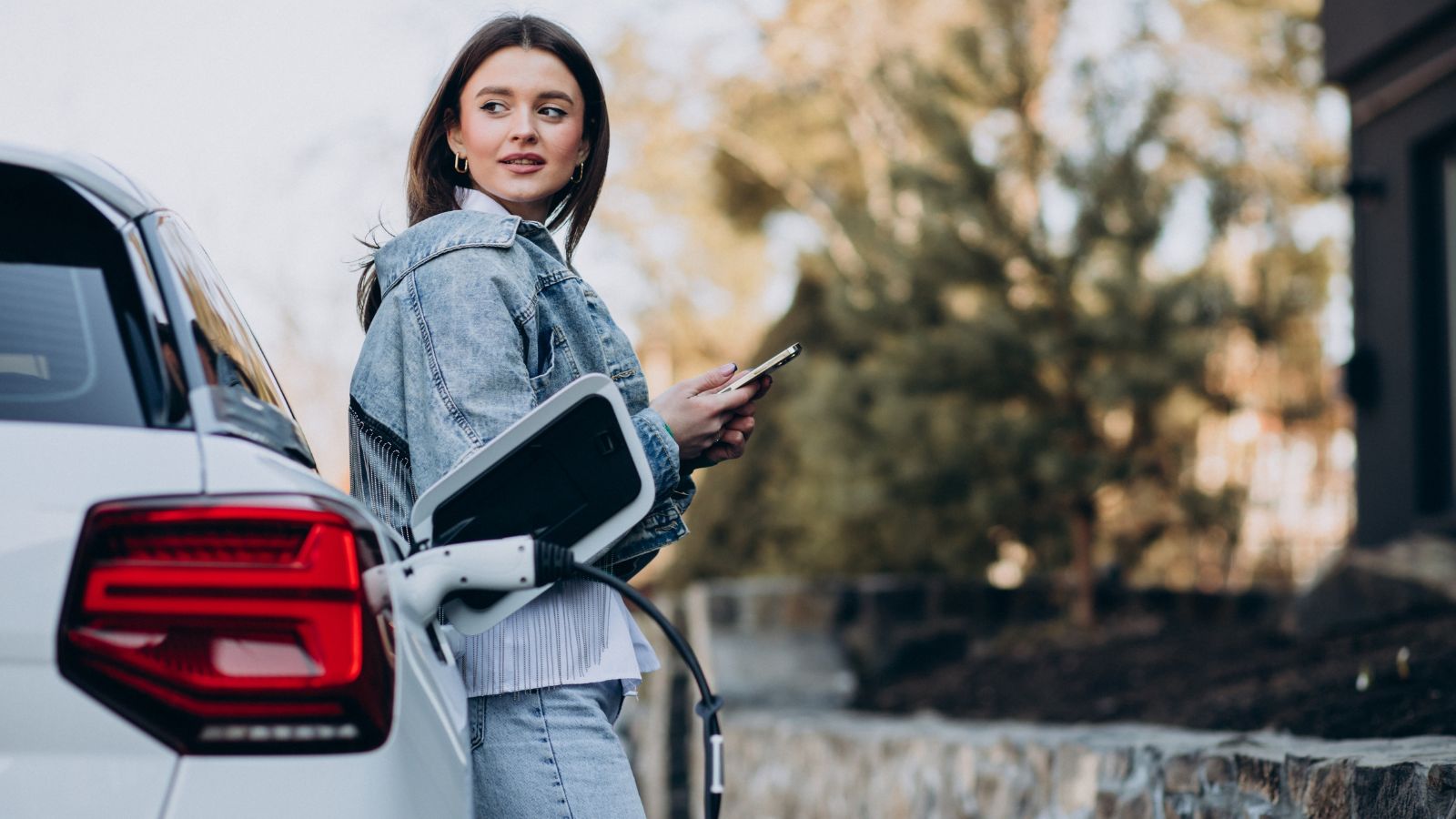 Woman charging her electric car