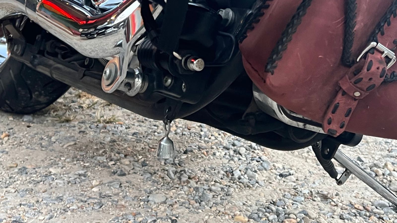 bell hanging underneath a motorcycle