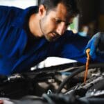 checking the oil level of the car engine