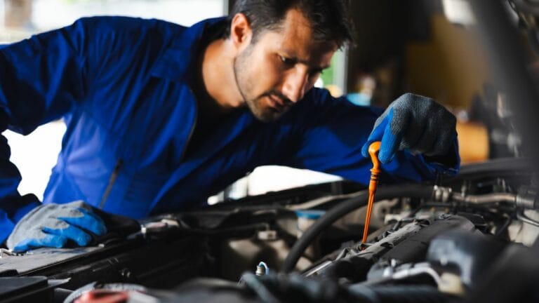 checking the oil level of the car engine