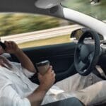 electric car mode of transport sitting inside driving on autopilot