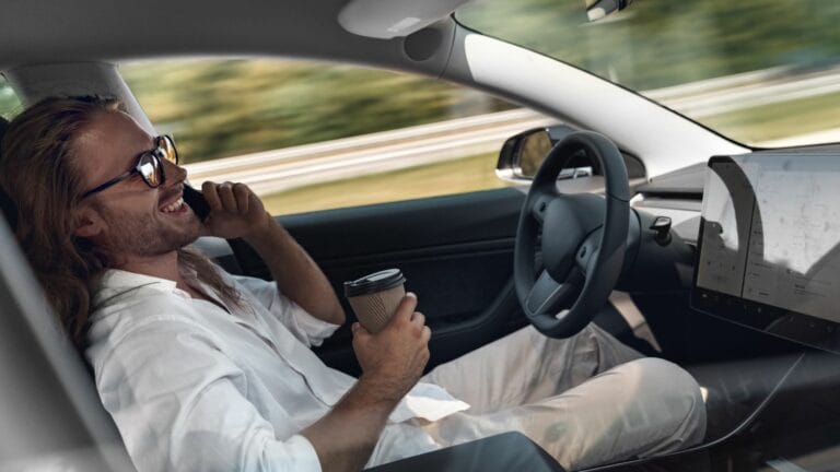 electric car mode of transport sitting inside driving on autopilot