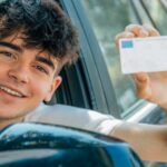 young nobel in the car with driver's license