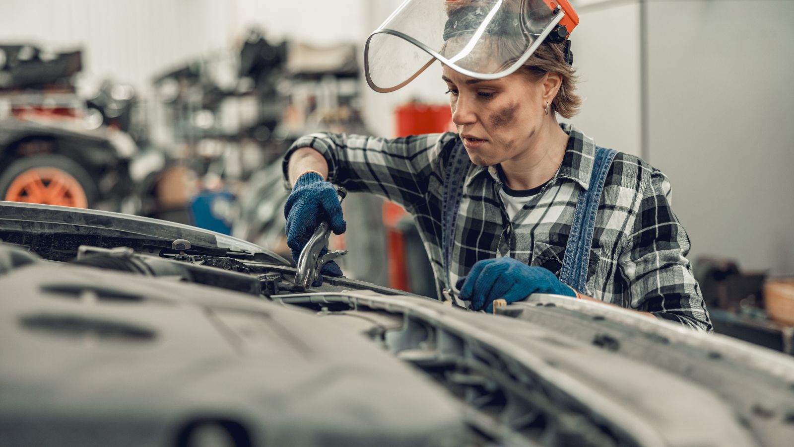 Female mechanic holding a pair of locking pliers
